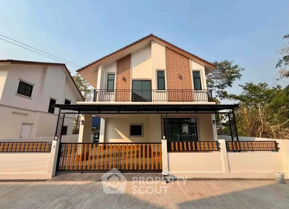 Modern two-story house with stylish facade and spacious balcony in a serene neighborhood.
