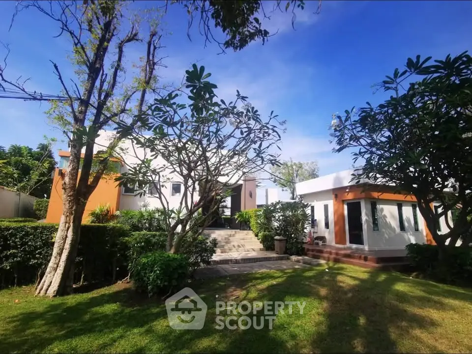 Charming modern home with lush garden and inviting entrance, perfect for serene living.