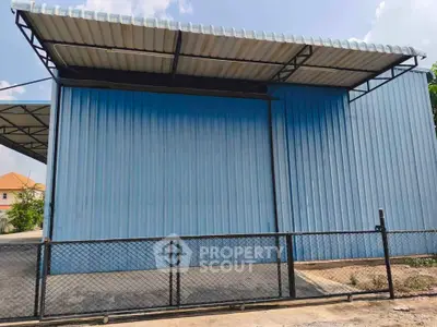 Spacious industrial warehouse with secure fencing and modern roofing.