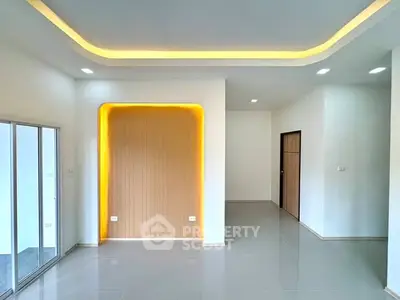 Modern minimalist living room with recessed lighting and sleek tile flooring