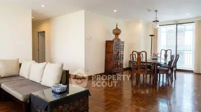 Spacious living and dining area with elegant wooden furniture and natural light.