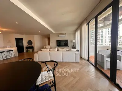 Spacious modern living room with elegant decor and large windows offering city views.