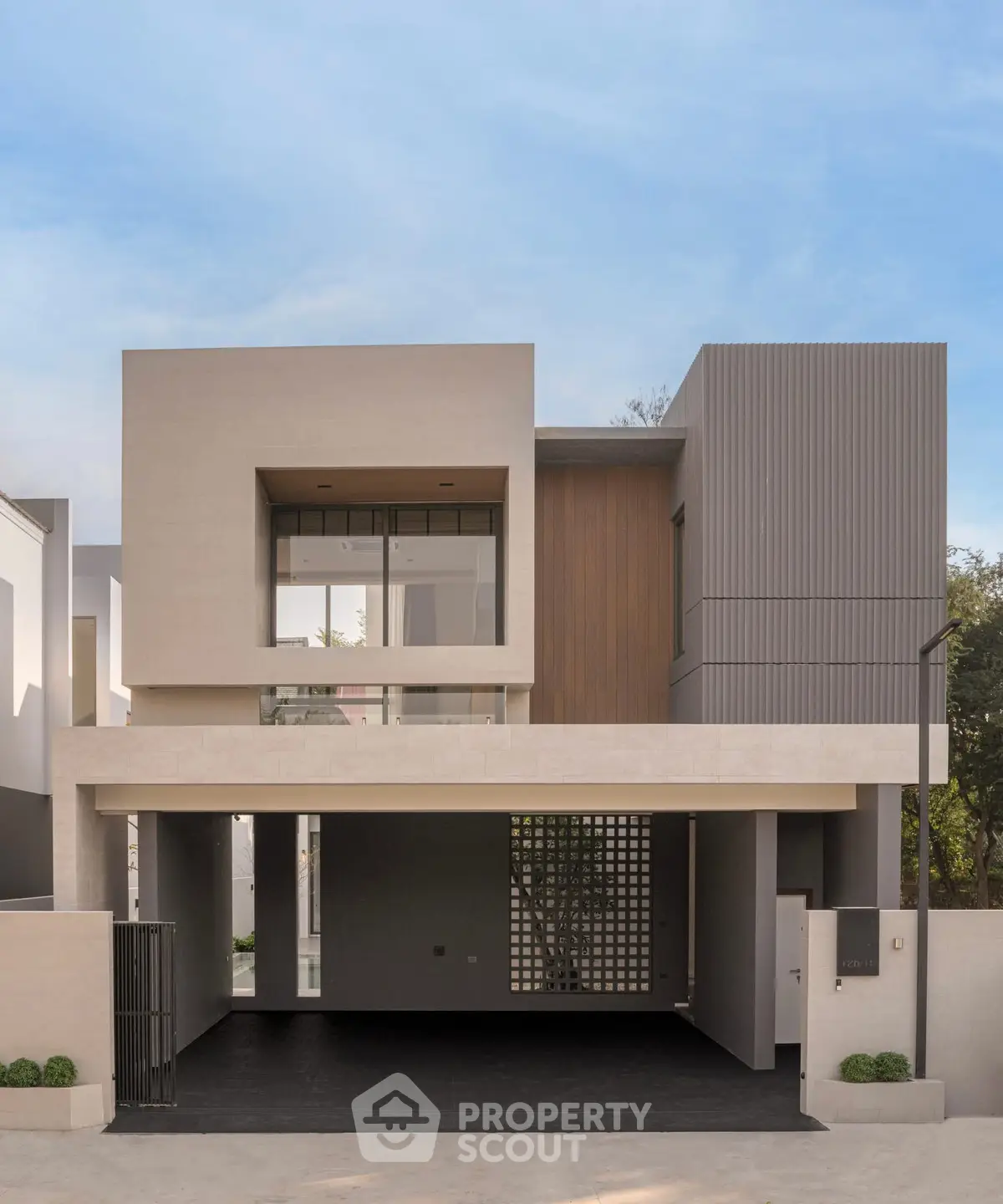 Modern architectural facade of a luxury home with clean lines and minimalist design.