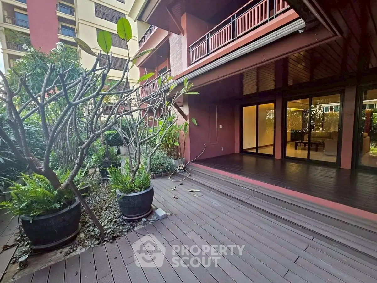 Spacious garden terrace with lush greenery and modern wooden decking