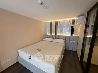 Modern bedroom with stylish lighting and comfortable bed in a cozy apartment.