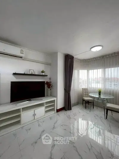 Modern living room with marble flooring and natural light