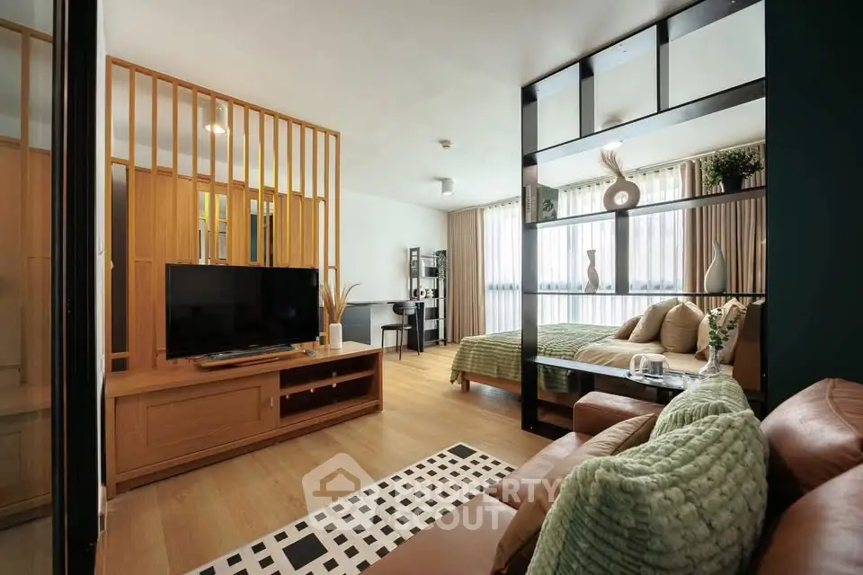 Modern open-plan living room and bedroom with stylish decor and natural light.