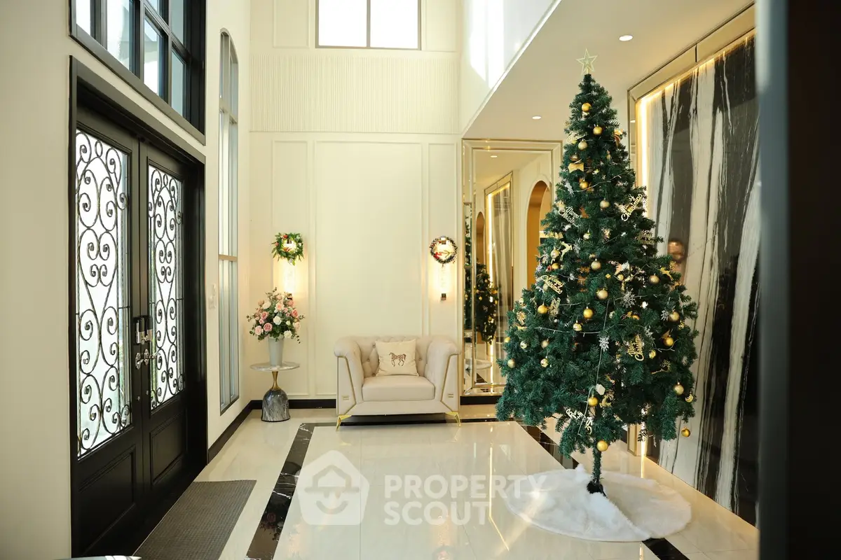 Luxurious entrance with elegant decor and festive Christmas tree