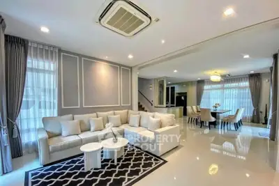 Luxurious open-plan living room with elegant decor and spacious dining area, perfect for modern family living.