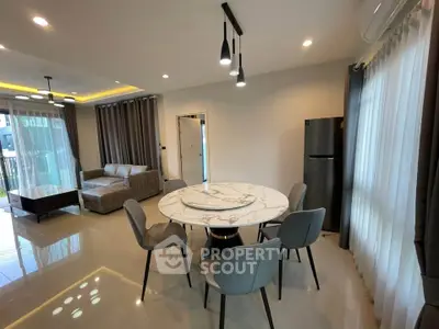 Modern open-plan living and dining area with stylish furniture and natural light.