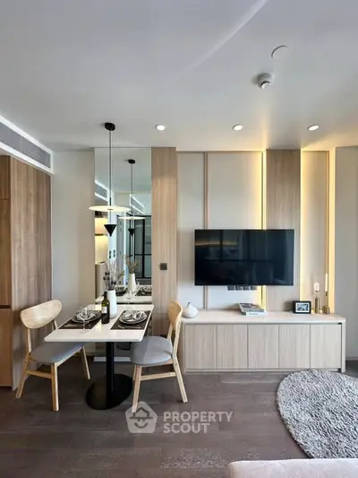 Modern living room with stylish dining area and wall-mounted TV, featuring elegant wood finishes and cozy lighting.