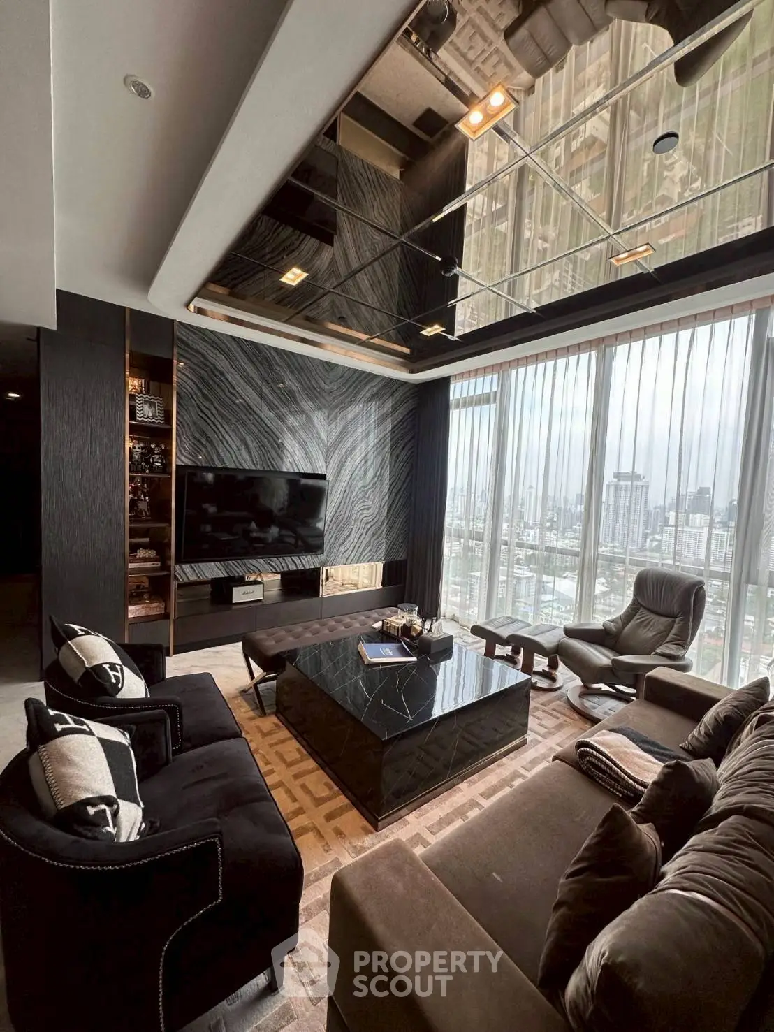 Luxurious modern living room with panoramic city views and elegant furnishings.