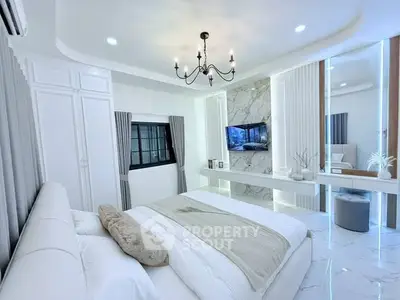 Luxurious modern bedroom with elegant chandelier and marble accents