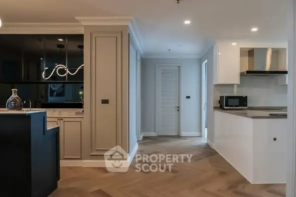 Modern kitchen with sleek design and open layout, featuring stylish cabinetry and contemporary lighting.