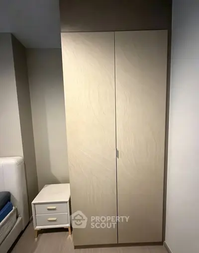 Modern bedroom with sleek wardrobe and stylish nightstand