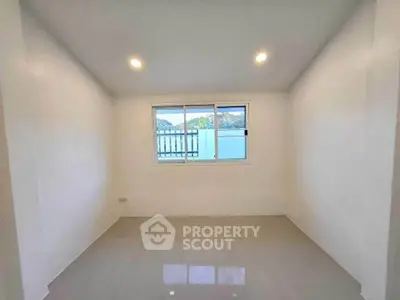 Spacious empty room with large window and glossy tiled floor, perfect for customization.