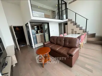 Spacious modern living room with loft design and elegant staircase