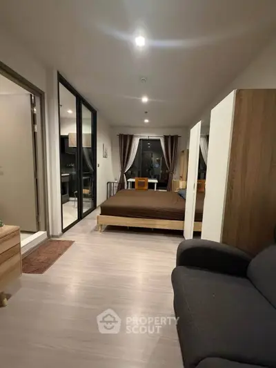 Modern bedroom with cozy lighting and stylish decor in a contemporary apartment.