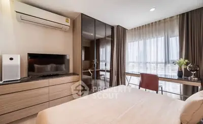 Modern bedroom with sleek furniture and large windows offering natural light.