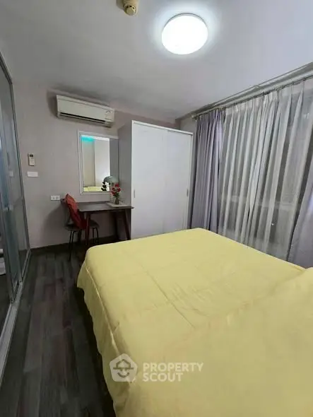 Cozy bedroom with modern decor, featuring a comfortable bed, stylish wardrobe, and a compact study area.
