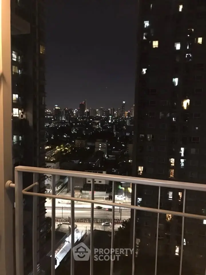 Stunning cityscape night view from high-rise balcony, perfect urban living experience.