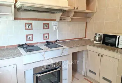 Modern kitchen with granite countertops and built-in oven