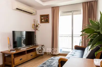 Charming living room with modern decor and large window for natural light.