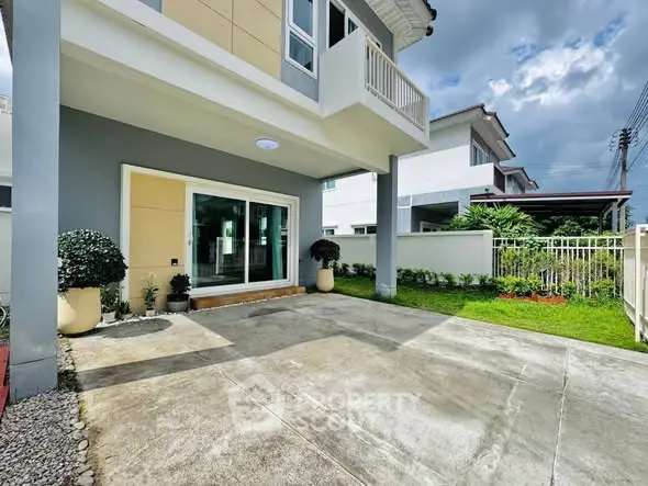 Modern house exterior with spacious driveway and landscaped garden