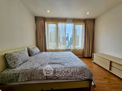 Spacious bedroom with city view and natural light in modern apartment