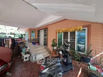 Charming home entrance with covered porch and scooter parking, perfect for cozy living.