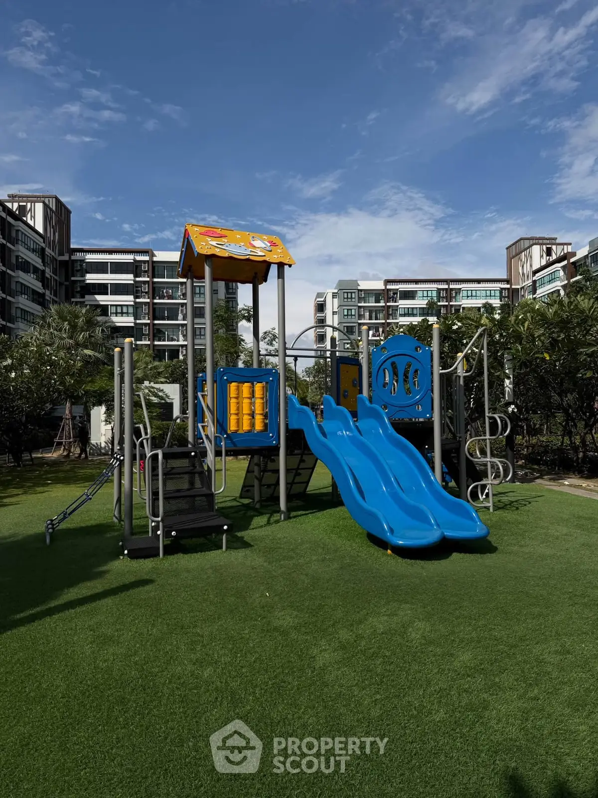 Modern residential complex with vibrant playground and lush greenery