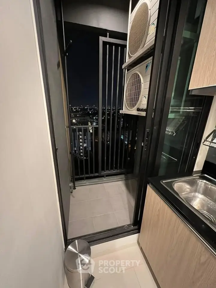 Modern apartment balcony with city view and kitchen access