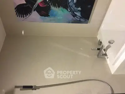 Modern bathroom with sleek fixtures and artistic wall decor