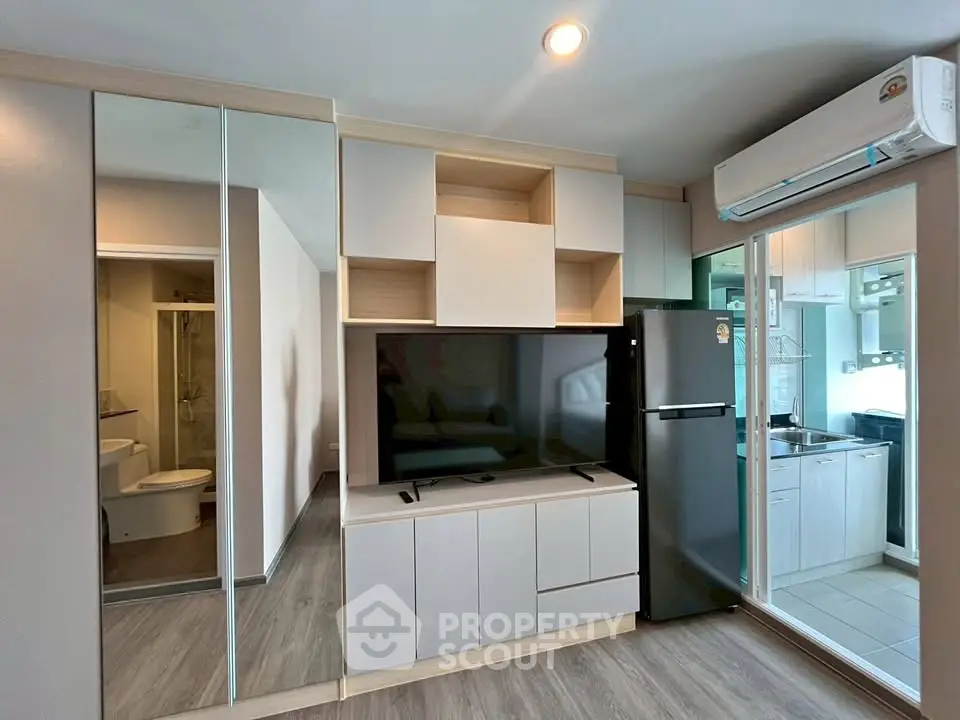 Modern living room with sleek TV unit and mirrored wardrobe