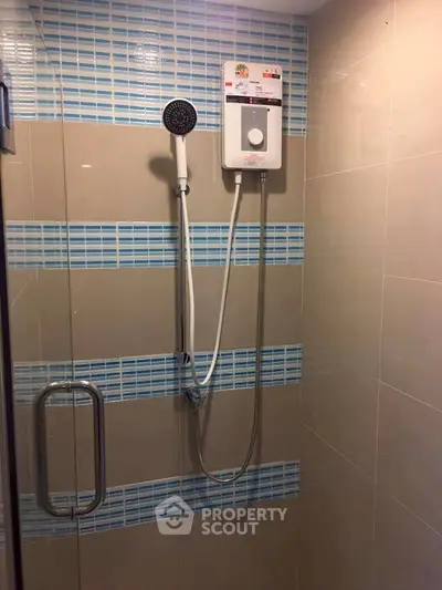 Modern bathroom shower with sleek design and blue tile accents