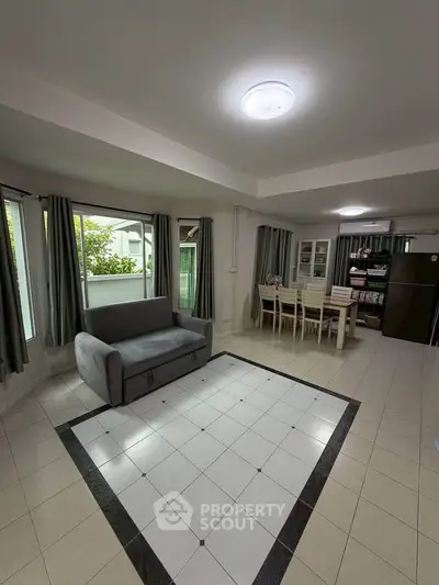 Spacious living room with modern decor and large windows for natural light