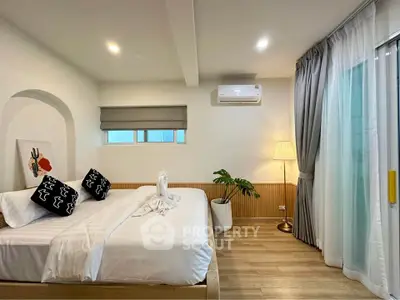 Modern bedroom with stylish decor and natural light