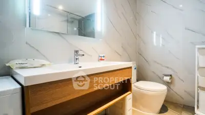 Modern bathroom with sleek design and elegant fixtures in a contemporary home.