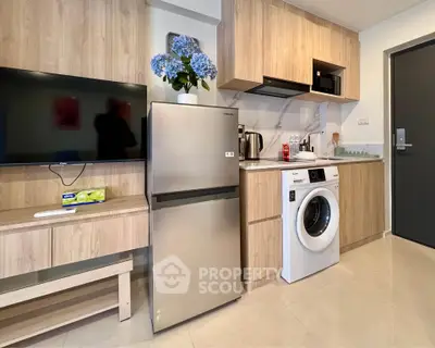 Modern kitchen with sleek appliances and stylish cabinetry in a compact layout.