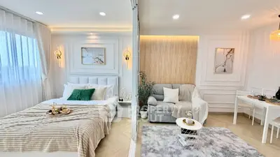 Luxurious modern bedroom and living room with elegant decor and cozy ambiance.