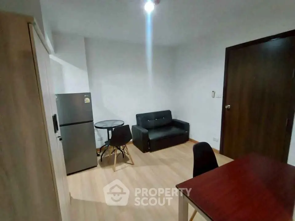 Cozy living room with modern furniture and compact design in urban apartment.