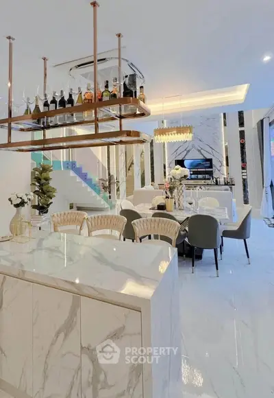 Luxurious open-plan living area with marble finishes and elegant decor, perfect for modern living.