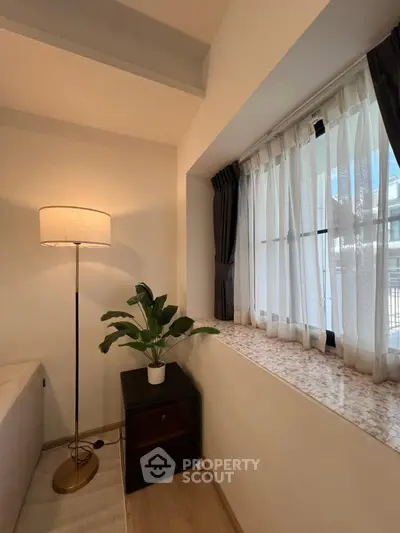 Cozy corner with floor lamp and window view in modern living room