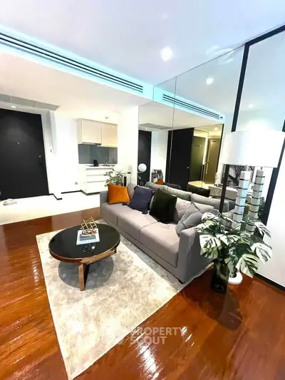 Modern living room with stylish decor, hardwood floors, and cozy seating area in a contemporary apartment.