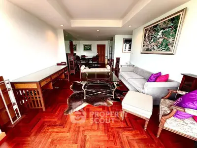 Spacious living room with elegant hardwood flooring and stylish furniture, perfect for modern living.