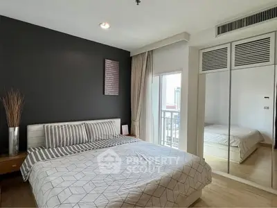 Modern bedroom with mirrored closet and city view from window