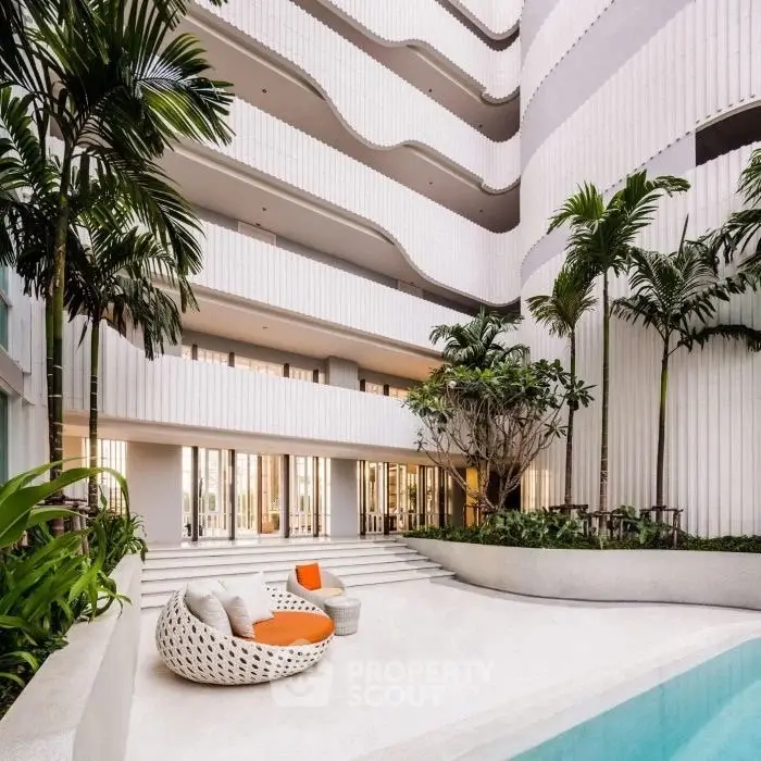 Luxurious modern building with pool and lush greenery, perfect for urban living.