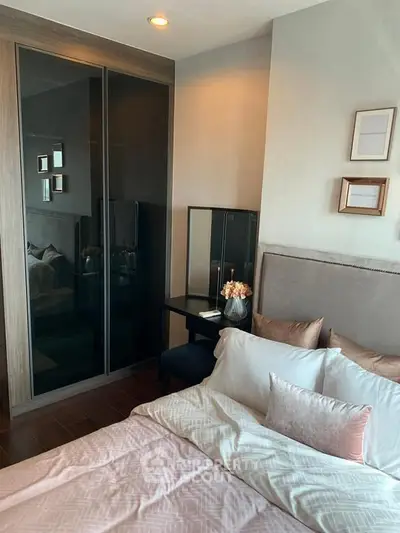 Cozy bedroom with elegant decor and modern furniture, featuring a plush bed and stylish wardrobe.