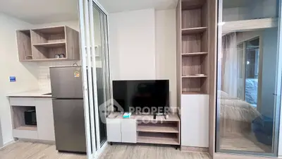 Modern studio apartment with sleek kitchen and cozy living area