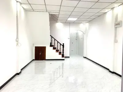 Spacious white interior with modern staircase and glossy tiled floor, perfect for customization.